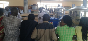 Aine Evans making a presentation with KRC and WFP Staff about the plastic and Metallic Silos in Hoima during the meeting recently — at Hoima. 