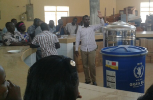 Aine Evans making a presentation with KRC and WFP Staff about the plastic and Metallic Silos in Hoima during the meeting recently — at Hoima. 